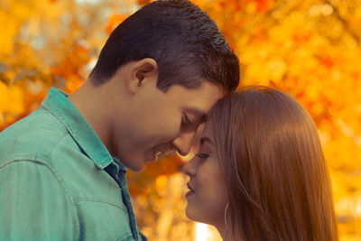 Close-up of young couple in park during autumn
