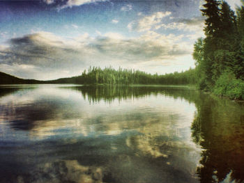 Scenic view of lake against cloudy sky