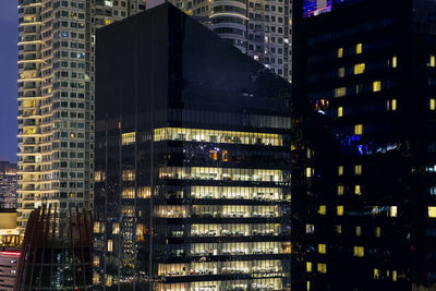 Digital composite image of modern buildings at night