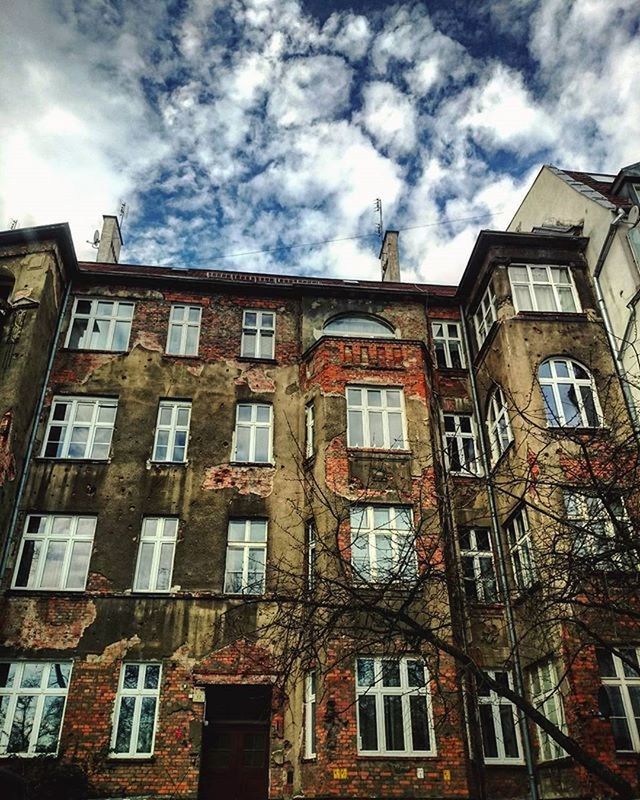 architecture, building exterior, built structure, window, low angle view, sky, cloud - sky, building, residential building, cloudy, residential structure, cloud, day, city, outdoors, no people, facade, old, house, apartment