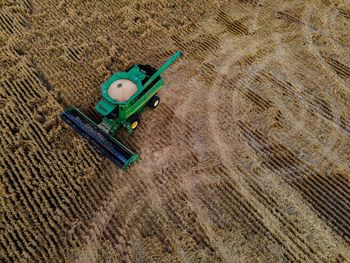 High angle view of a combine harvester cutting wheat