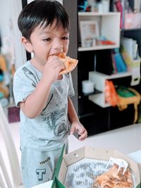 Boy eating food at home