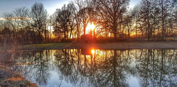 Reflection of sun in lake during sunset