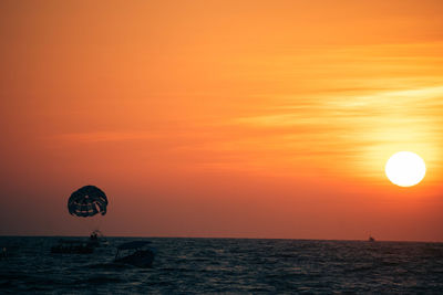 Scenic view of sea against orange sky