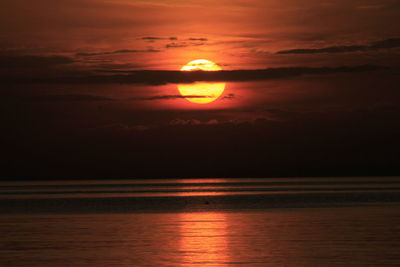 Scenic view of sea against romantic sky at sunset