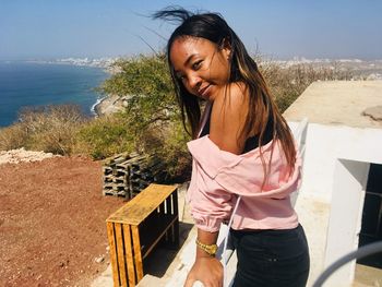 Portrait of young woman standing outdoors