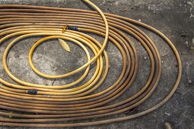High angle view of garden hose on field