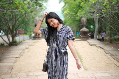 Young woman standing on footpath