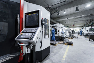 Technicians working and operating machinery in industry