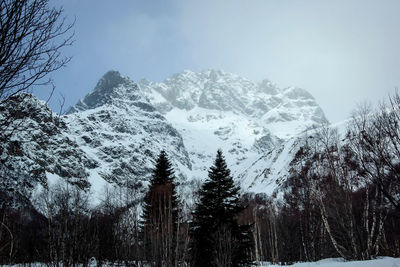 Scenic view of snow covered mountains against sky