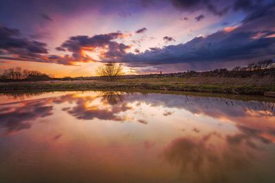 Scenic view of lake against sky at dusk