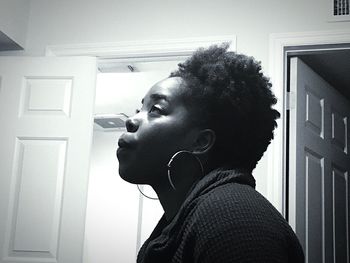 Portrait of young man looking away at home