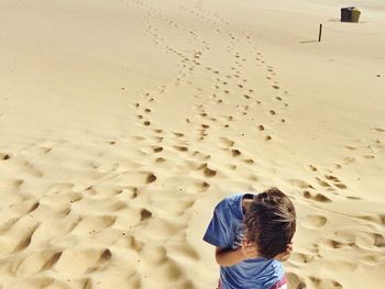 Boy standing on beach at praia do guincho