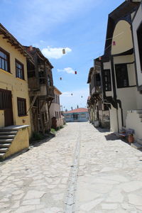 Footpath amidst buildings in town