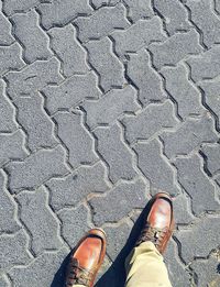 Low section of man standing on footpath