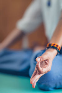 Low section of woman doing yoga at home