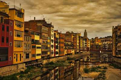 Buildings in city against sky at dusk