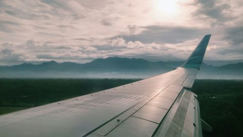 Cropped image of landscape against clouds