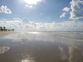 View of beach against cloudy sky