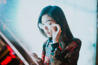 Portrait of woman holding camera