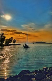 Silhouette of boat sailing in sea