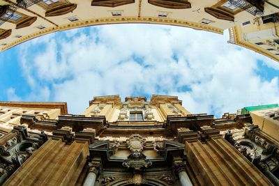 Low angle view of historic building against cloudy sky