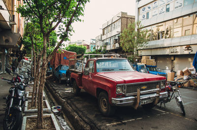 Vehicles on road amidst buildings in city