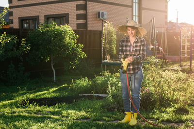 Person standing by plants in yard