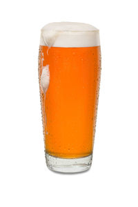 Close-up of beer glass against white background