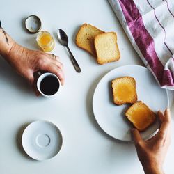 Close-up of cropped hand holding coffee