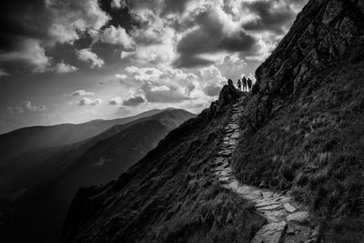 Scenic view of mountains against cloudy sky