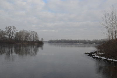 Scenic view of lake against sky during winter