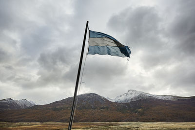 Low angle view of flag against mountain range