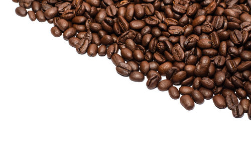 Close-up of coffee beans against white background