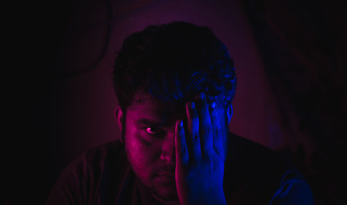 Portrait of man in darkroom