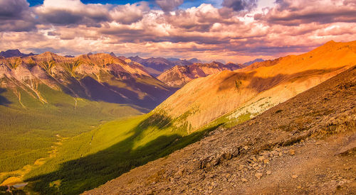 Scenic view of mountains against cloudy sky