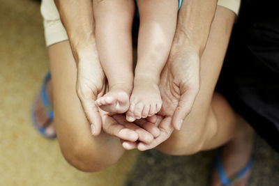 Childs feet on mothers hands