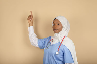 Portrait of woman standing against white background