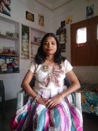 Portrait of young woman sitting at home