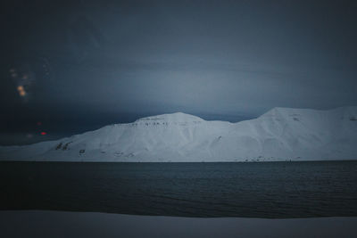 Shadow of man walking on road