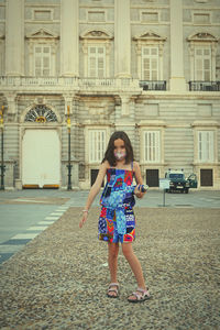 Portrait of a young woman standing in city