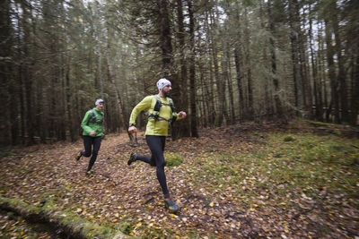 Man and woman running in forest