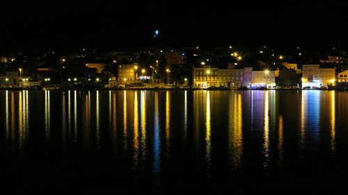 Reflection of illuminated buildings in water at night