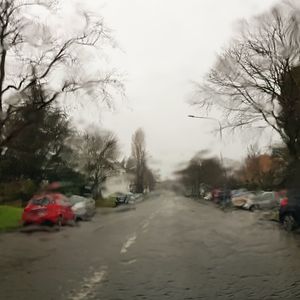 Cars on road against sky during winter