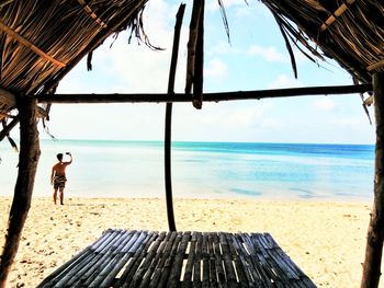 Man on beach against sky