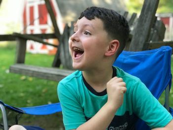 Portrait of smiling boy looking away outdoors