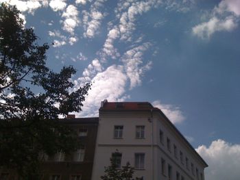 Low angle view of building against cloudy sky