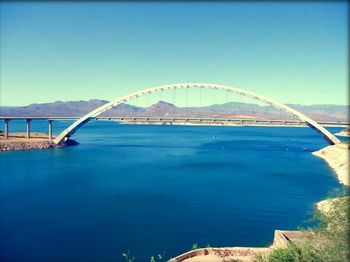 Bridge over river against blue sky