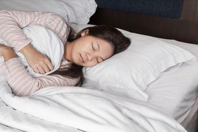 High angle view of baby sleeping on bed at home