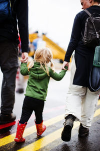 Girl walking with parents